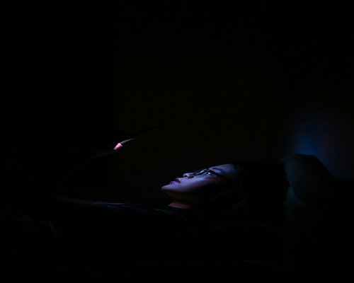 Person reading tablet in dark room